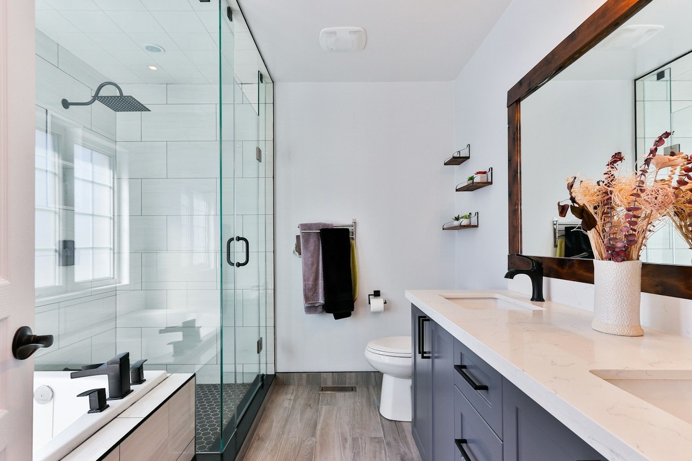 A finished modern bathroom with a glass shower